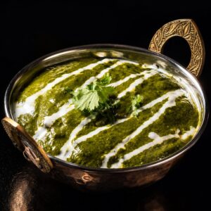 Authentic Indian Palak Paneer served in a traditional copper bowl at Shiva's Garden Indian Restaurant in Villingen-Schwenningen, Germany.
